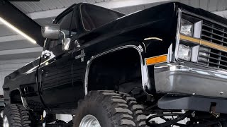 Beautiful, black, classic square body lifted 4 x 4 truck old-school 4wheel drive