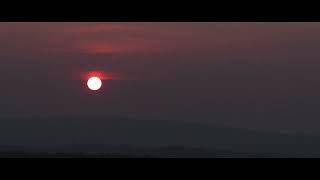 The Sun Impossibly Sets In Front Of The Clouds