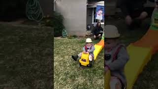 Kid rides toy car down track and flips over