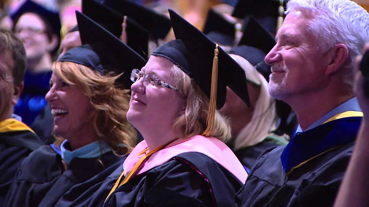 Faculty sitting with cap and gown