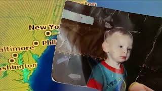 Holding Jeffrey's Photo By the State of New Jersey on the Map of the Arrivals and Departures Screen
