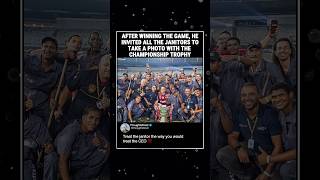 After winning the game, he invited all the janitors to take a photo with the championship trophy