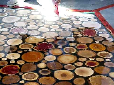 Spreading the epoxy over sanded wooden disks - YouTube