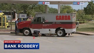 Armored truck robbed at gunpoint outside suburban bank
