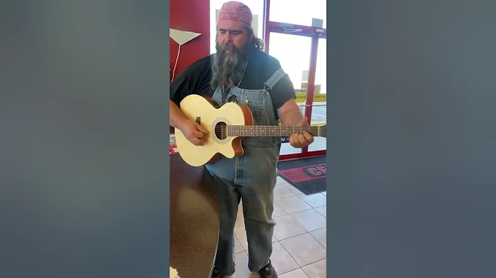 Johnny Webb playing guitar in cefco