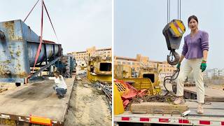 Heavy Lift in Action. Female Crane Operator Heze Loading Massive Industrial Equipment onto Trailer