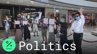 A lunchtime protest takes place at major shopping center in hong kong,
almost week after china imposed national security law on the city.
protesters sing...