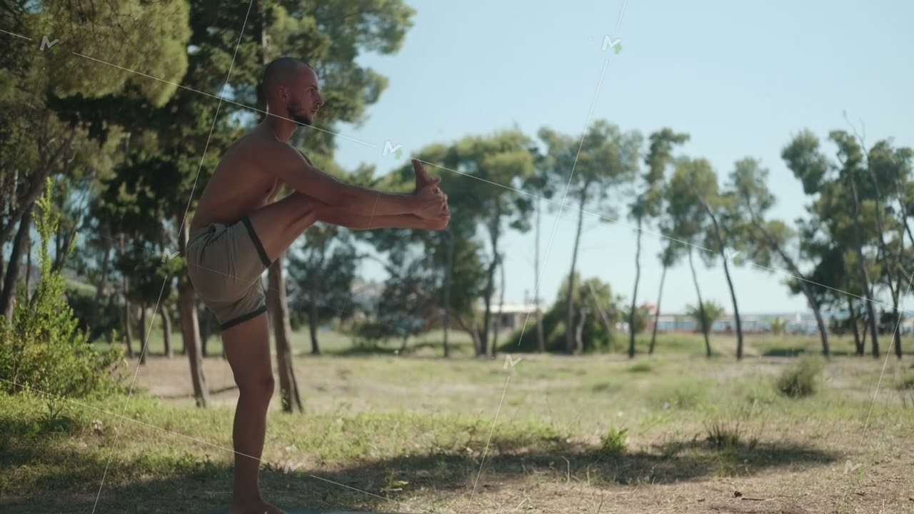 Solo yoga practice in city park. Yoga master demonstrates an asana.