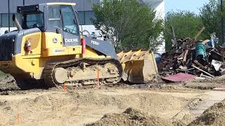 Track loader moving trash