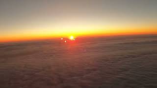 Sunrise over the clouds as the plane flies over the state of New York by Radha Chetan 102 views 5 months ago 1 minute, 2 seconds