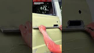Skilled Worker Restores A Vehicle Door Panel Through A Precision Repair Process
