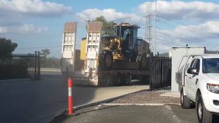 Caterpillar 140M Grader Leaving the Yard