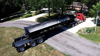 Side Dump Trailer unloading rock for a gravel driveway - Jet Trailers