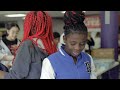 KCPS's Northeast Middle School and Chief's players pack backpacks