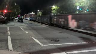 A BNSF mixed freight with 4 locomotives heads south down Winslow Street in Fayetteville 5/28/2026