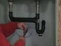 The Old plumber shows how to Install drain pipes on a kitchen sink..