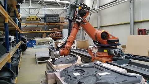 Trimming carbon fiber parts by KUKA KR210 on linear track. 5D contouring Trimming