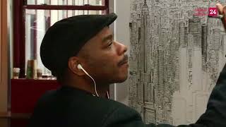 British autistic artist Stephen Wiltshire signs finished drawing of NYC skyline