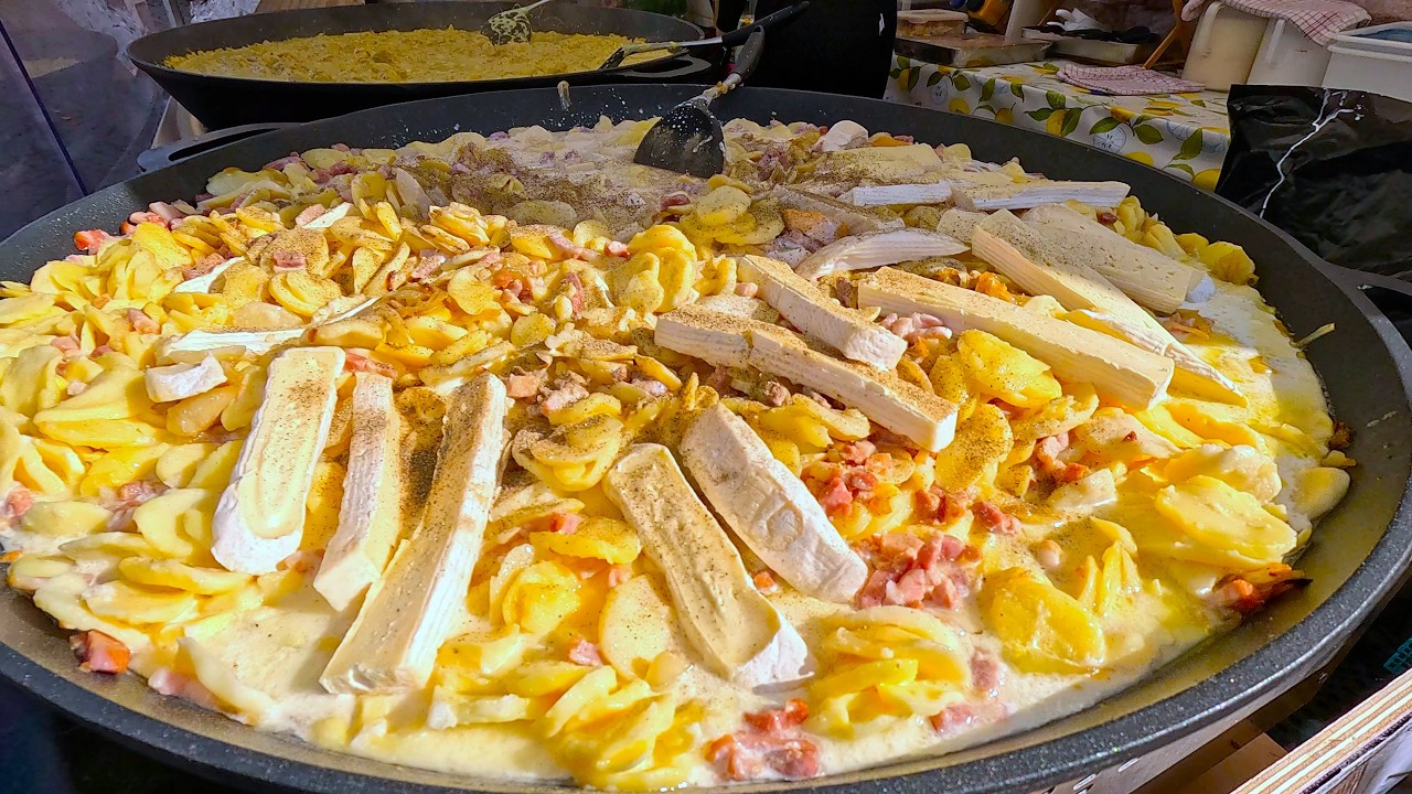 French Food at Street Food Festival. Tartiflette, Chicken with Mustard Sauce, Much More