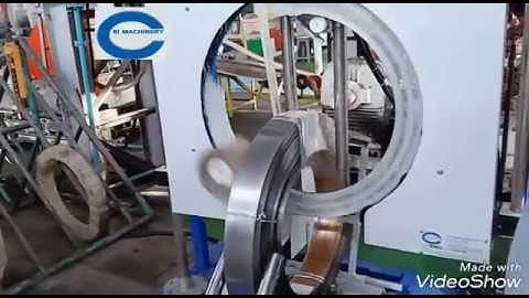 Vertical steel coil wrapping machine with motorized ting up down system