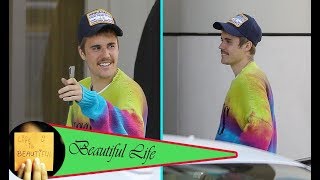 Justin Bieber rocks a rainbow sweater and huge grin after having a 'trespasser' in his room