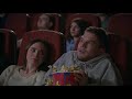 .blocks young couple watching horror film in movie theatre guy sprinkle popcorn on girl in movie