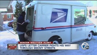 USPS letter carrier fights his way through snowy streets