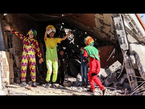 Palestinians dressed as clowns entertain children in Gaza