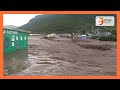 Water rushing through the streets of Sindo town as floods overwhelm the town in Homa Bay County