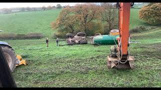 John Deere and tanker rolled over down hill recovered by J & R Millington