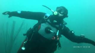 Female Diver is Diving with Neoprene Drysuit