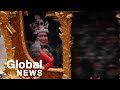 Hologram of young Queen waves from Gold State Coach during Jubilee pageant