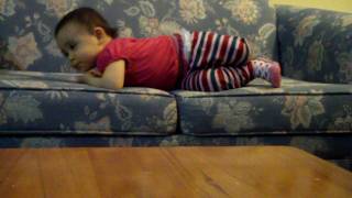 Audrey Sofia climbing up to the sofa at 1 year old