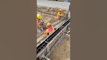 Technical women workers install beam rebar of fence