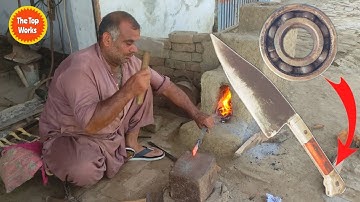 Skilled blacksmith making a skinner knife out of a rusty bearing
