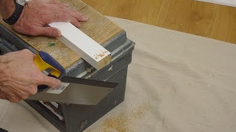 Installing plantation shutters onto a UPVC window using wooden battens.