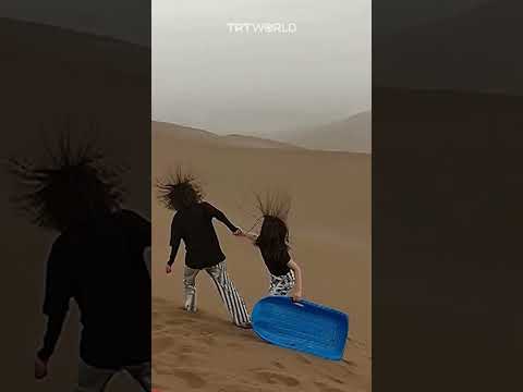 Electrically Charged Clouds In Desert Make Tourists Hair Stand On End