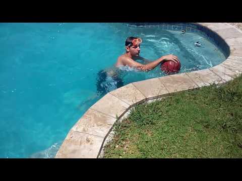 Boys are played football in the pool