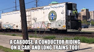 A caboose, a conductor riding a car and long trains too!
