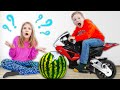 Amelia and Akim play with watermelon and toys in the garden