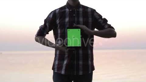 Man Holding a Tablet With a Green Screen - Stock Footage | VideoHive 13092789