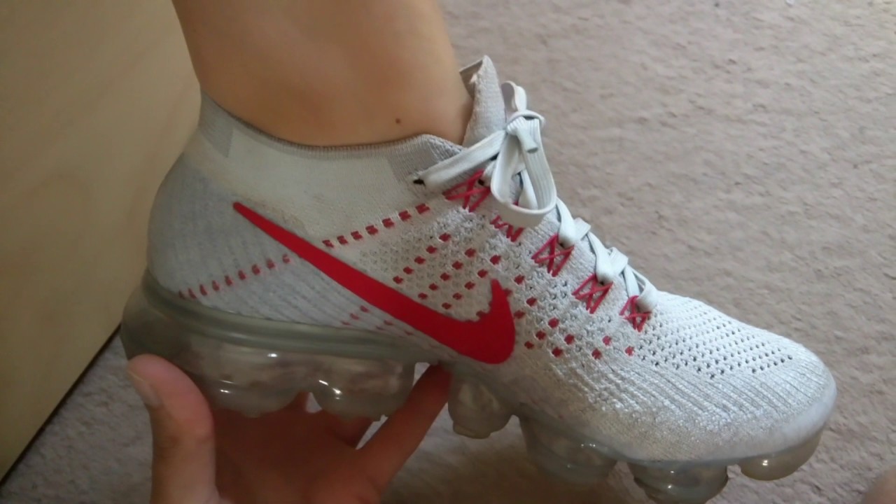 Removing her Nike Vapormax
