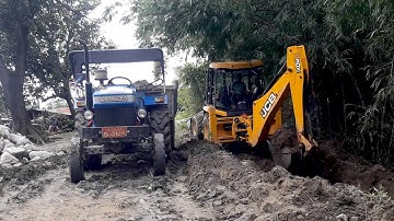 JCB Backhoe 3DX Machine Making Drain And Loading Soil in Tractor