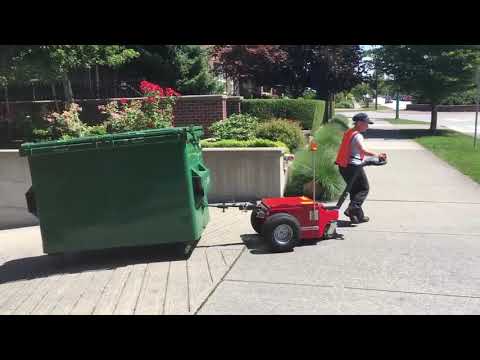 V-Move XL+ dumpster mover taking bin up driveway from multi-unit underground garage
