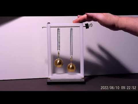 BOUNCING BRASS BALLS: Micro-gravity between two objects revealed.