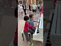 Two amazing talented 6yearold kids playing duet on a public street piano