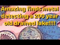 amazing relics,coins,and much more!! metal detecting a 200 year old drained lake.