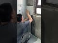 the process of installing ceramic tiles on the wall under the window of a building room #popular