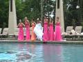 bride and bridesmaids jump in pool