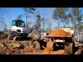 Mini Excavator Loading A Track Truck